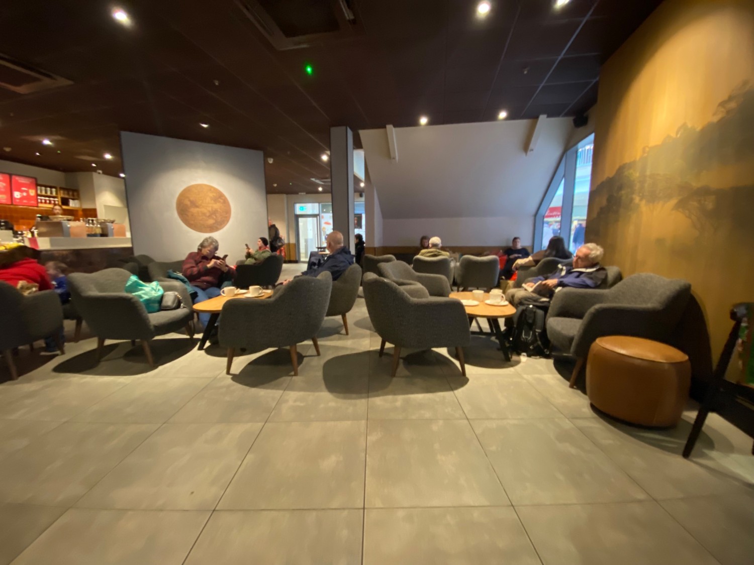 Slightly in front of entrance facing right.
Low tables, armchairs straight ahead.