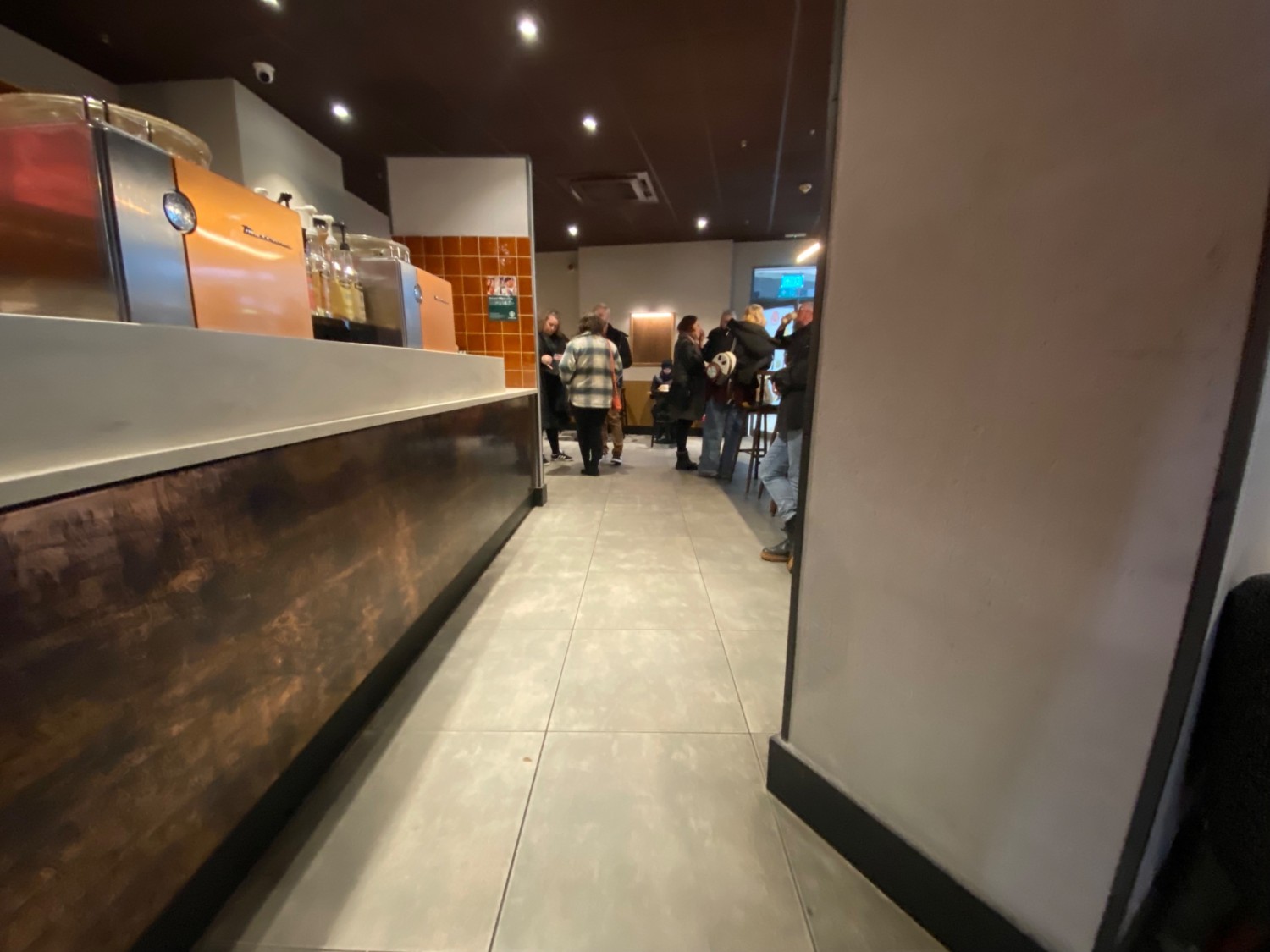 From counter facing right. Path leads straight along right side of counter. Large pillar to right.