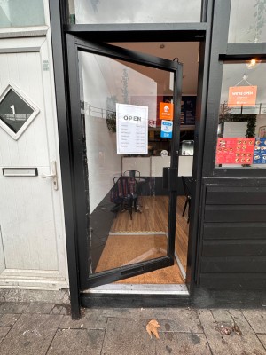 Glass and metal door ahead. Push from right to open.