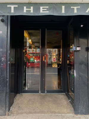 Double glass doors ahead. Pull left door by metal handle on right to open.
