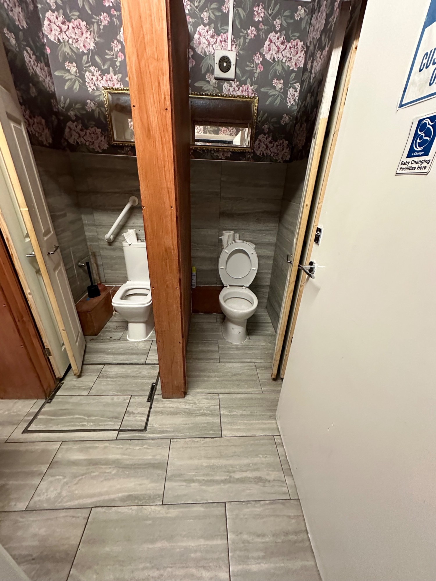 From main bathroom door, two toilet cubicles straight ahead.