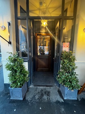 Glass double doors with dark blue frame. Push from middle to open.