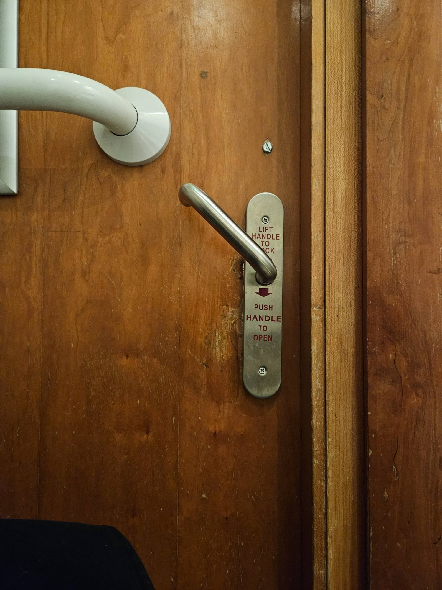 Lock inside the toilet. Turning lock mechanism. Lift handle up to lock. Push handle down to unlock and open.
