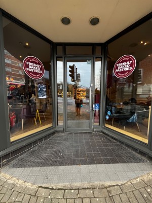 From pavement facing venue. Opening ahead, entrance at back.