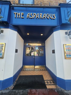 From pavement facing venue. Opening ahead followed by entrance. Doormat at foot of opening.