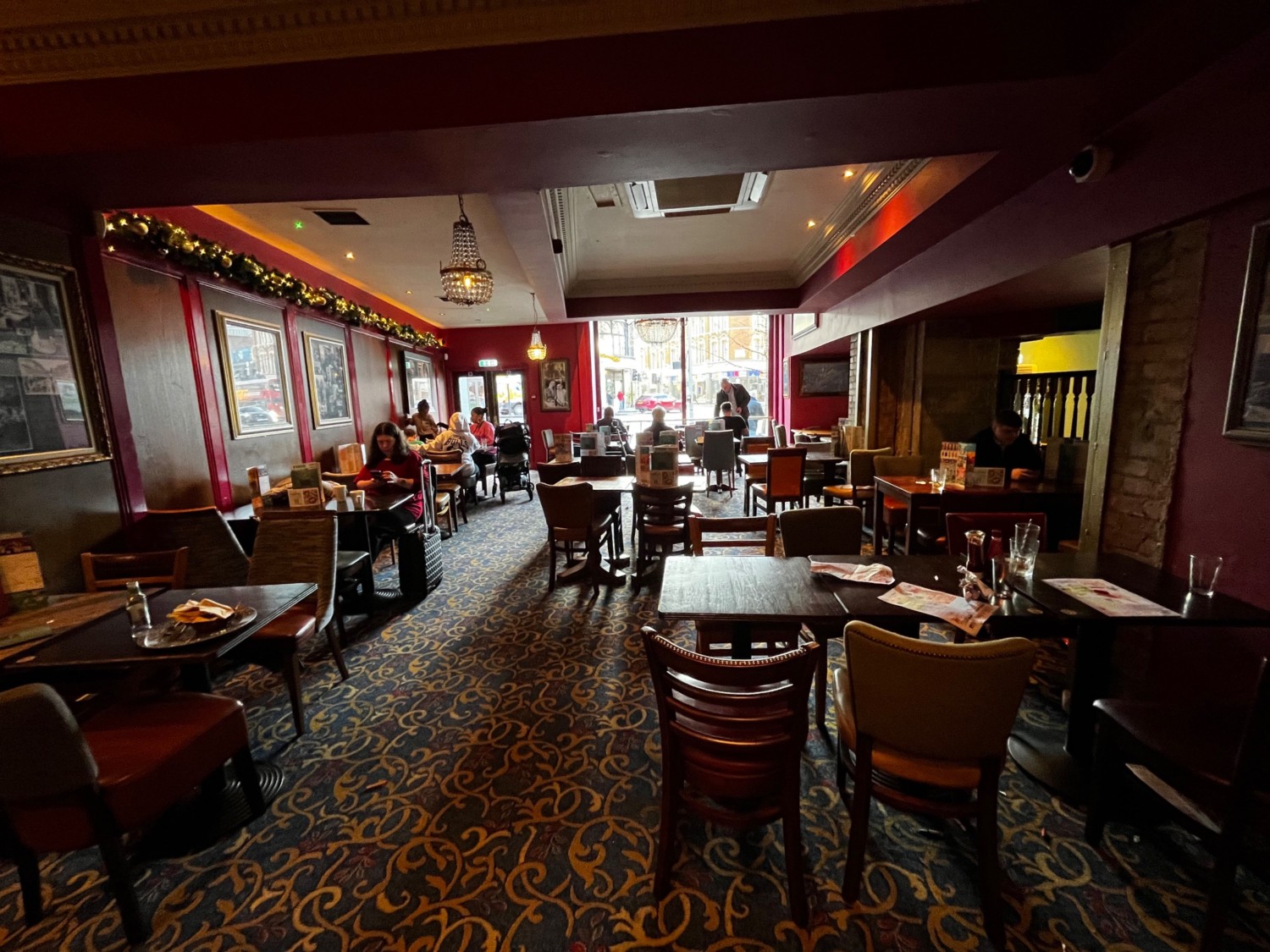 From after archway, facing right. Rows of tables and chairs ahead.