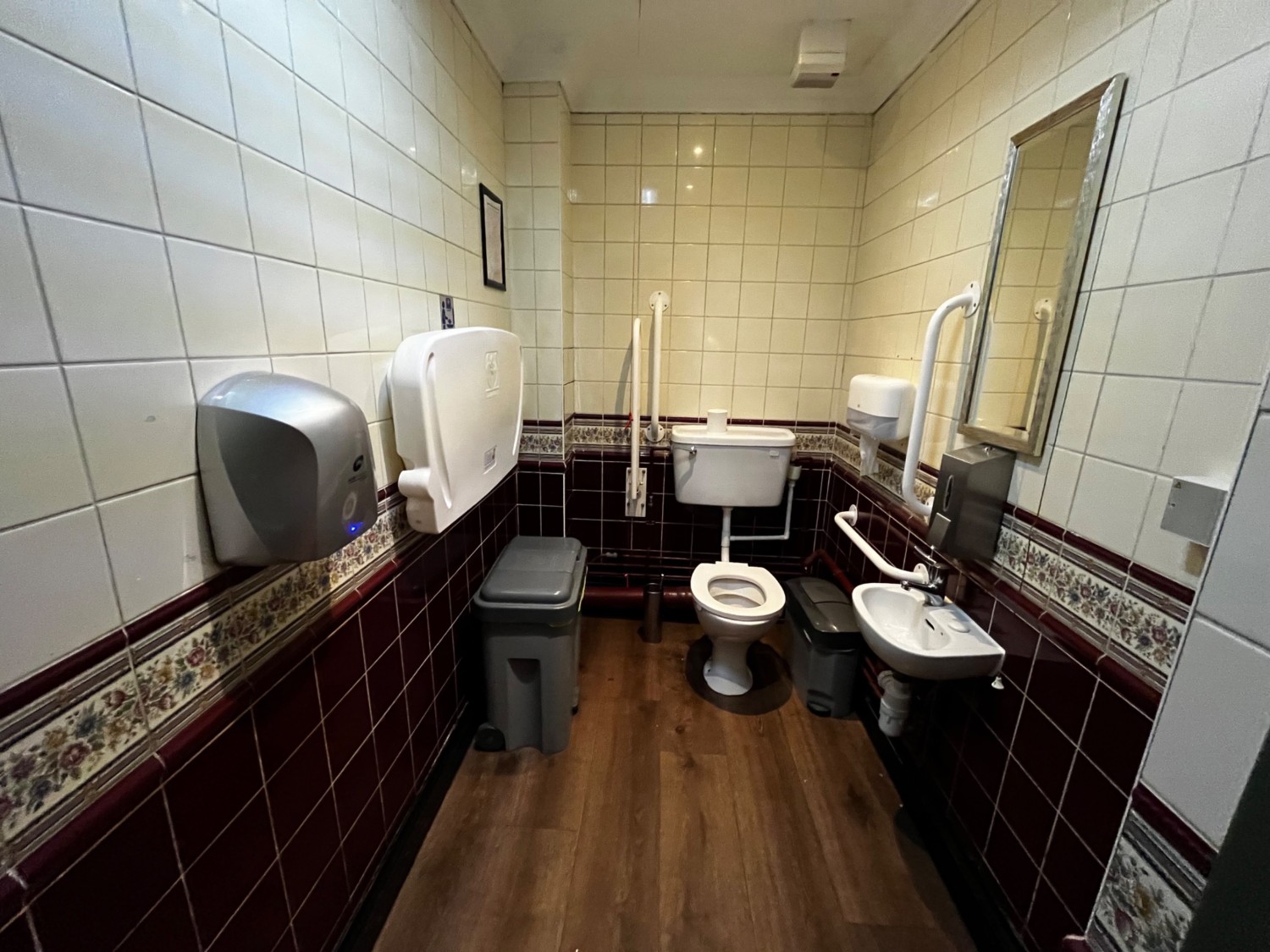 From door facing straight. Baby change to left. Toilet back right. Sink to right.