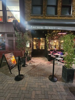 Path to entrance through outdoor front area. Built in ramp ahead leading to doors.