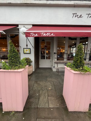 Pathway to entrance down centre. Pink plant pots obstructing to right and left.