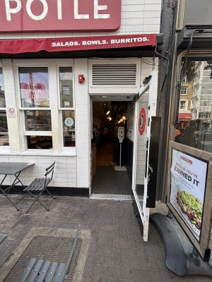 Glass door with white frame ahead. Pull from left to open.