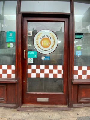 Glass door with wooden frame. Push from left to open.