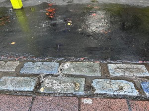 From street, facing floor. Cobbled flooring, followed by smooth concrete.