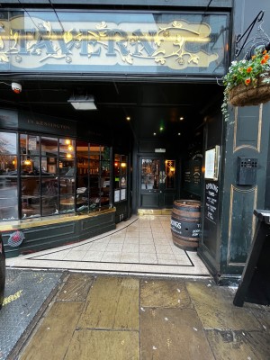 From street, facing venue. High table on right. Doorway at back.