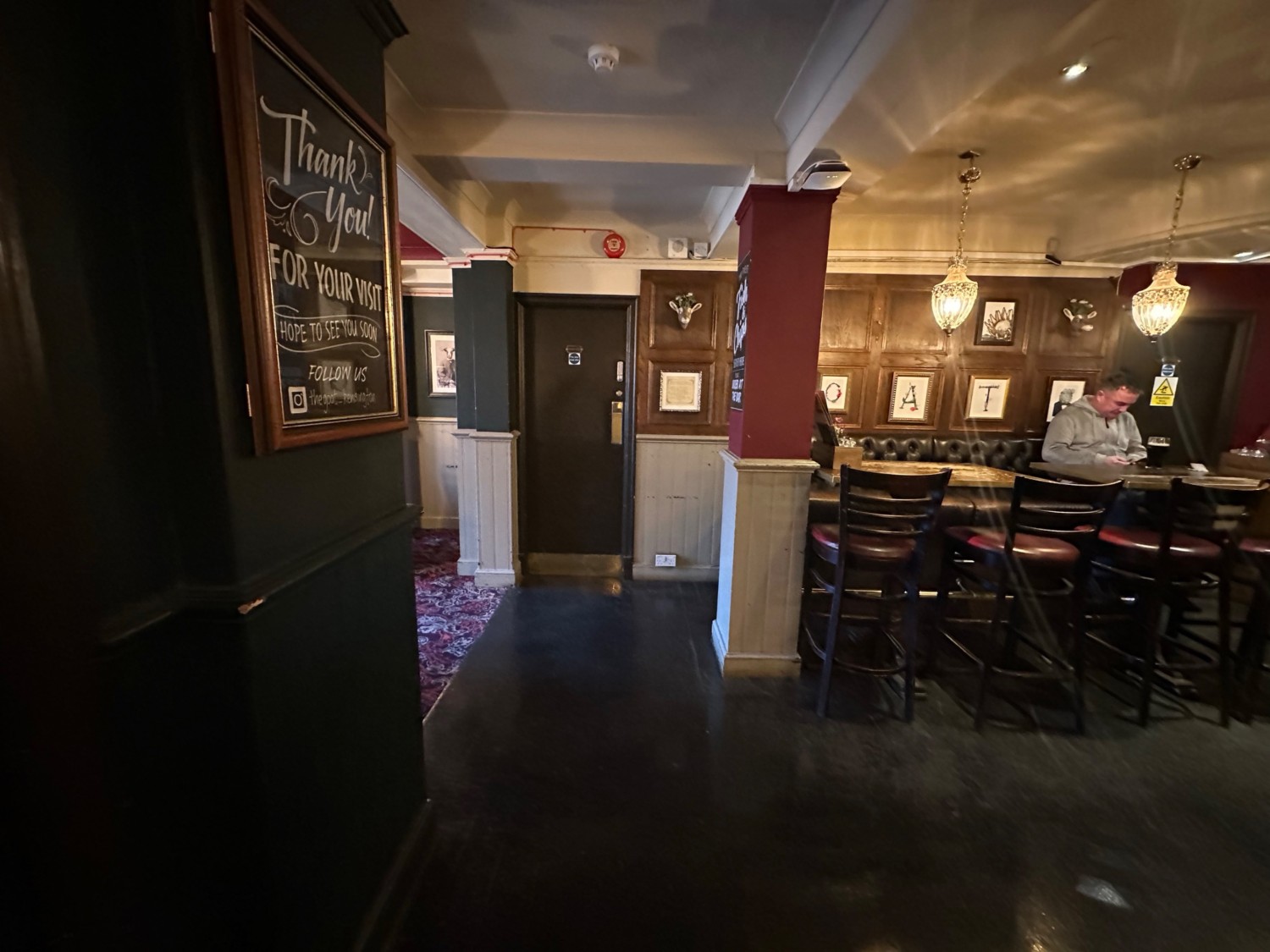 From entrance facing left. High half booth with stools at back right.