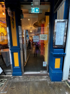 Glass door. Push silver handle on left to open.