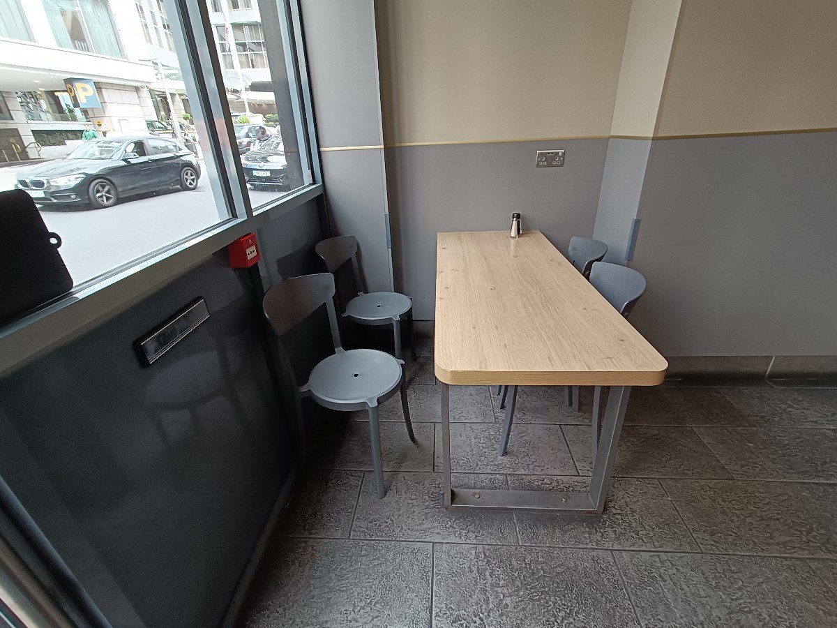 From entrance, facing left. Table, stools and chairs ahead.