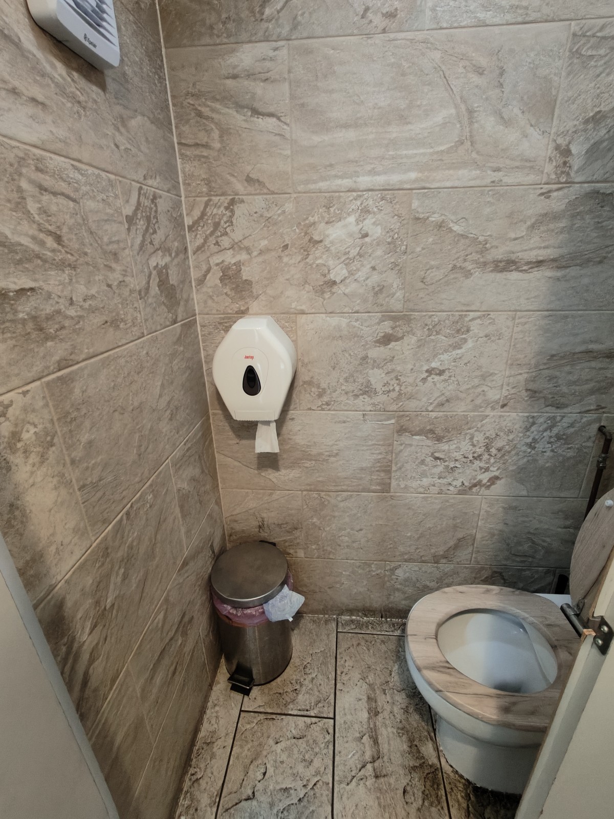 From door facing straight. Toilet on right.