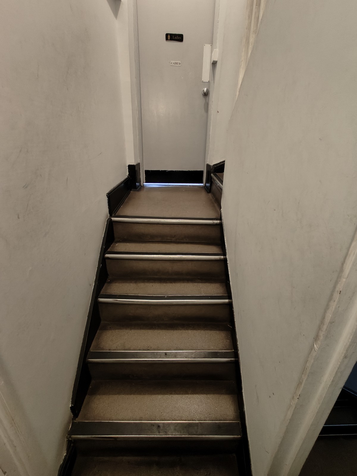 From after first preceding door facing right. Stairs continue up.