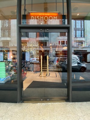 Black framed glass doors. Push golden handles in centre to open.