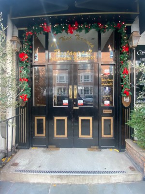 Double black doors with glass panels. Pull from handle in middle to open.