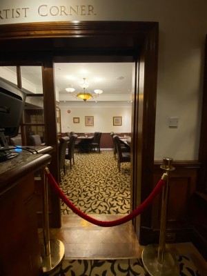 After preceding double doors facing right. Open archway straight ahead.