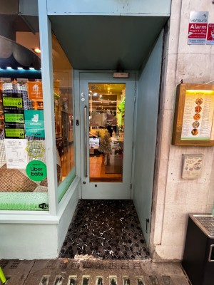 Glass door with pale green frame. Pull from left to open.