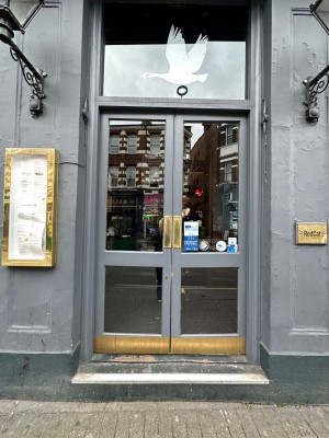 Grey framed wooden glass doors ahead. Push handles in centre to open.