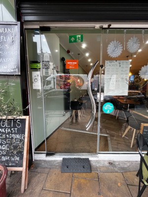 Glass door ahead. Push silver handle on right to open.
