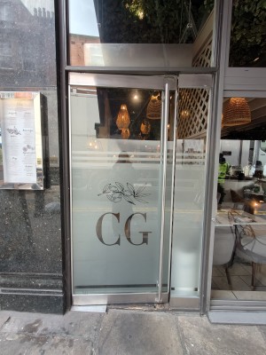 Glass doors. Push silver handle on right to open.