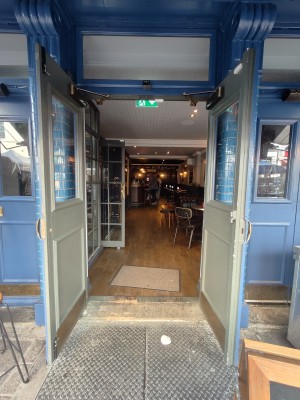 Green framed glass doors. Pull golden handles in centre to open.