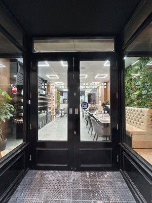 Double black bordered glass doors. Pull from middle to open.