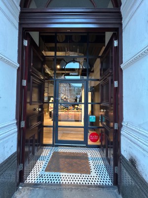 Preceding set of wooden doors lead to single glass door. Push from left to open.