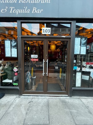 Glass double doors with brown frame. Push from middle to open.