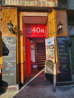 From street, looking straight at restaurant door. Red door. Push from right to open.