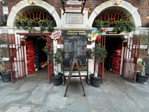 Two red metal gates on left and right of storefront.