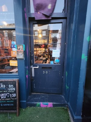 Glass door with blue wooden frame. Push silver handle on left to open.