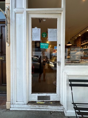 Wood and glass panelled door. Push from right.