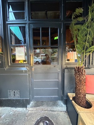 Preceding grey wooden door with glass panels.