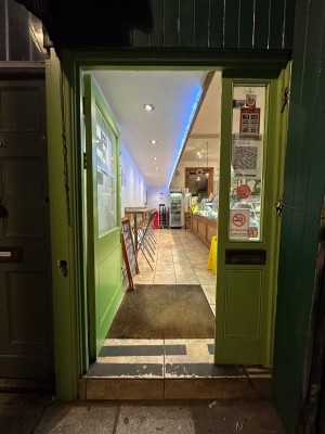 Glass doors with green frame. Push handle in centre to open.