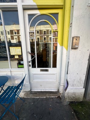 Facing front glass door. Push handle on right to open.