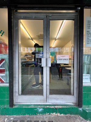 Glass panelled door. Push from centre.