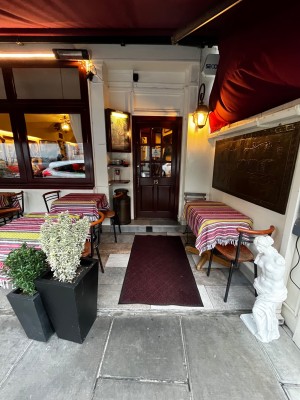 Path to entrance from street. Outdoor seating either side. Door ahead.