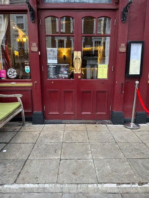 Red doors with glass panels and metal handles in centre. Pull to open.