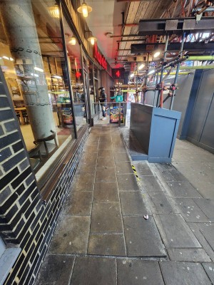 From street, looking at ramp parallel to restaurant. Ramp begins ahead.