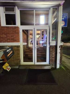 White bordered door. Handles in center. Pull to open.