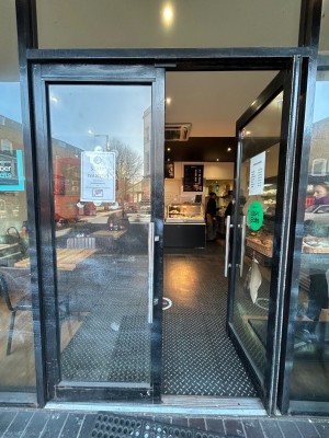 Double glass doors with black border. Push from middle to open.