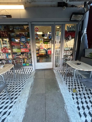 Path to door ahead. Metal and glass door, push from right to open.