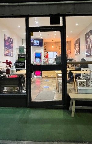 Glass door with black frame. Pull from left to open.