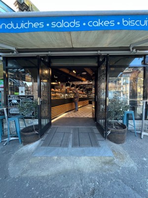 Glass doors with black frame ahead. Pull from centre to open.