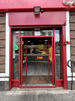 Glass doors with red frame ahead. Pull doors to open from center.